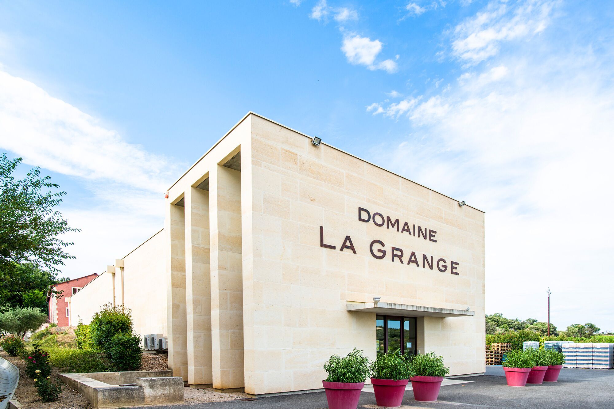 Ein Gebäude mit dem Schriftzug "DOMAINE LA GRANGE" an der Fassade.
