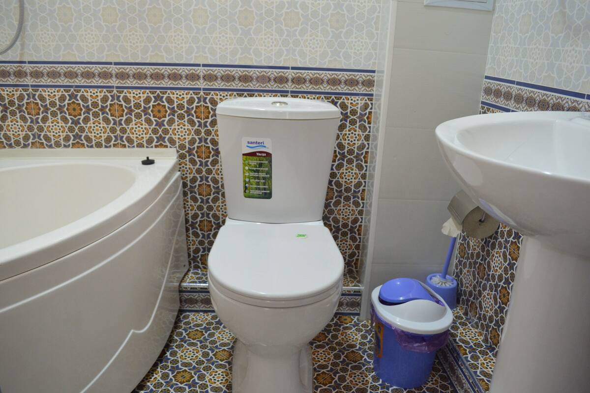 A bathroom with a toilet, a bathtub, and a sink.