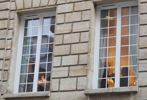 Stunning building facade with elegant window frames and a stone structure.
