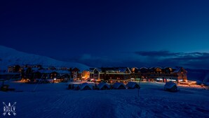 A snow-covered hotel with multiple buildings, ski lifts, and tents. - 2-room apartment NFT 452 New Gudauri (Gudauri)
