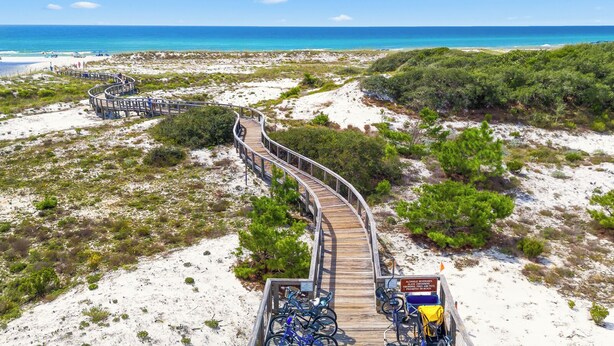 A wooden boardwalk leading to a beach with clear blue water and sandy dunes. - Watersound - Golf Cart - Pet Friendly - Bikes (Watersound)