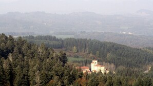 A mountainous landscape with a church surrounded by dense forest. - HOUSE IN A SMALL CHARMING VILLAGE: GOOD PRICE-QUALITY RATIO (AUZELLES)
