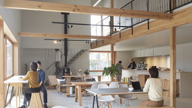 A spacious, multi-level interior with wooden beams, high ceilings, and ample natural light.