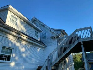 A two-story house with a visible staircase leading to the upper floor. - Relax, Zen condo, with AC, country side & lakes (Stanstead)