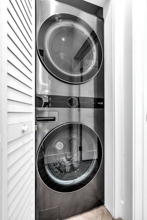 Convenient washer and dryer unit with two washing drums and a dryer, perfect for laundry needs.
