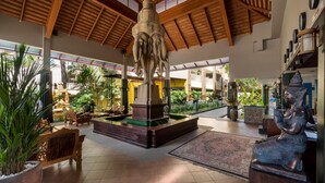 A spacious lobby with a central fountain, wooden ceiling, and a statue of a seated figure. - Tuana Hotels Casa Del Sol (Karon)