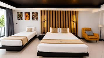 A hotel room with two beds, a modern chair, and artwork on the wall.