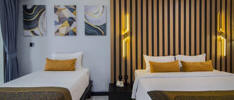 A hotel room with two beds, a nightstand, and abstract artwork on the walls.