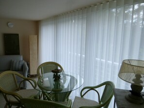 Relax in this serene space with a glass-top dining table and comfortable seating for four.