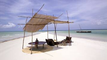 On the beach, white sand, sun loungers, beach volleyball