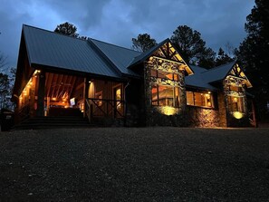 A rustic lodge with a stone facade, wooden beams, and a metal roof.