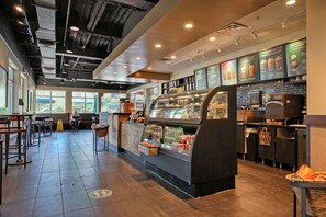 Relax in a casual atmosphere with a central counter, seating area, and large window.
