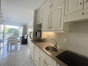 Fridge, coffee/tea maker, electric kettle, cookware/dishes/utensils