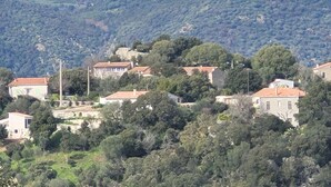 A hillside village with traditional stone buildings, dense greenery, and a mountainous backdrop. - Sheepfold in dry stones with outdoor spa, calm assured  (Granace)