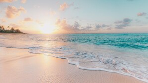 A beach with gentle waves and a sunset. - Limited Time Deal 45% Discount - Best Value on LBK (Longboat Key)