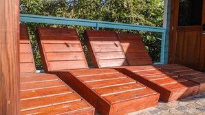 A wooden deck with built-in seating. - Cozy 1 Bedroom Suite with Easy Beach Access (West Bay)
