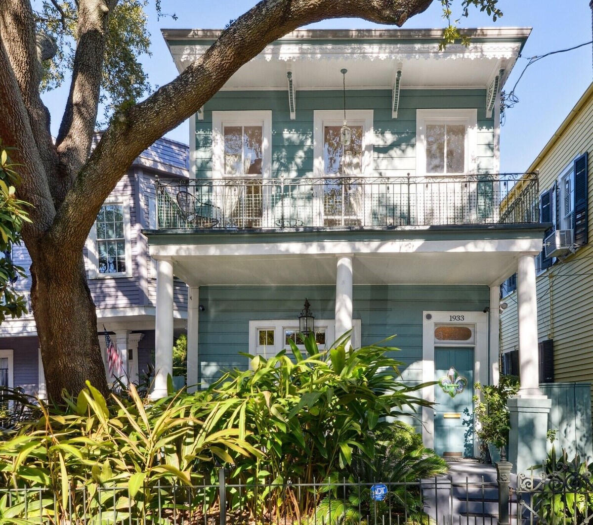 Historic Property With Balcony Lookout into Trees and Pre Civil War buildings.