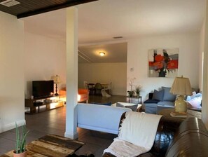 Relax in this stylish living room with a comfortable sofa, flat-screen TV, and a coffee table.