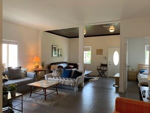 Relax in this stylish living area with a sofa set, coffee table, and dining table.
