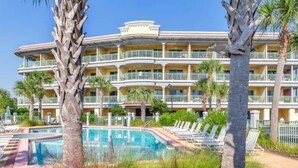 A hotel with a pool area, palm trees, and a multi-story building with balconies. - Romantic getaway Luxe 30A Beach, 2 Free Bikes right between Alys Beach &Rosemary (Panama City Beach)