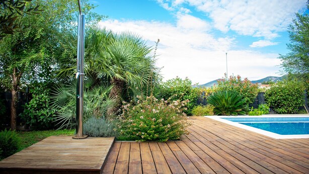 A wooden deck with a pool, surrounded by lush greenery and a clear sky. - Villa Grey - Three Bedroom Villa with Swimming pool (Kastel Kambelovac)