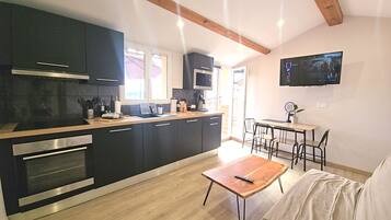 Apartment with cinema and terrace | Private kitchen | Espresso maker, coffee/tea maker, electric kettle, highchair