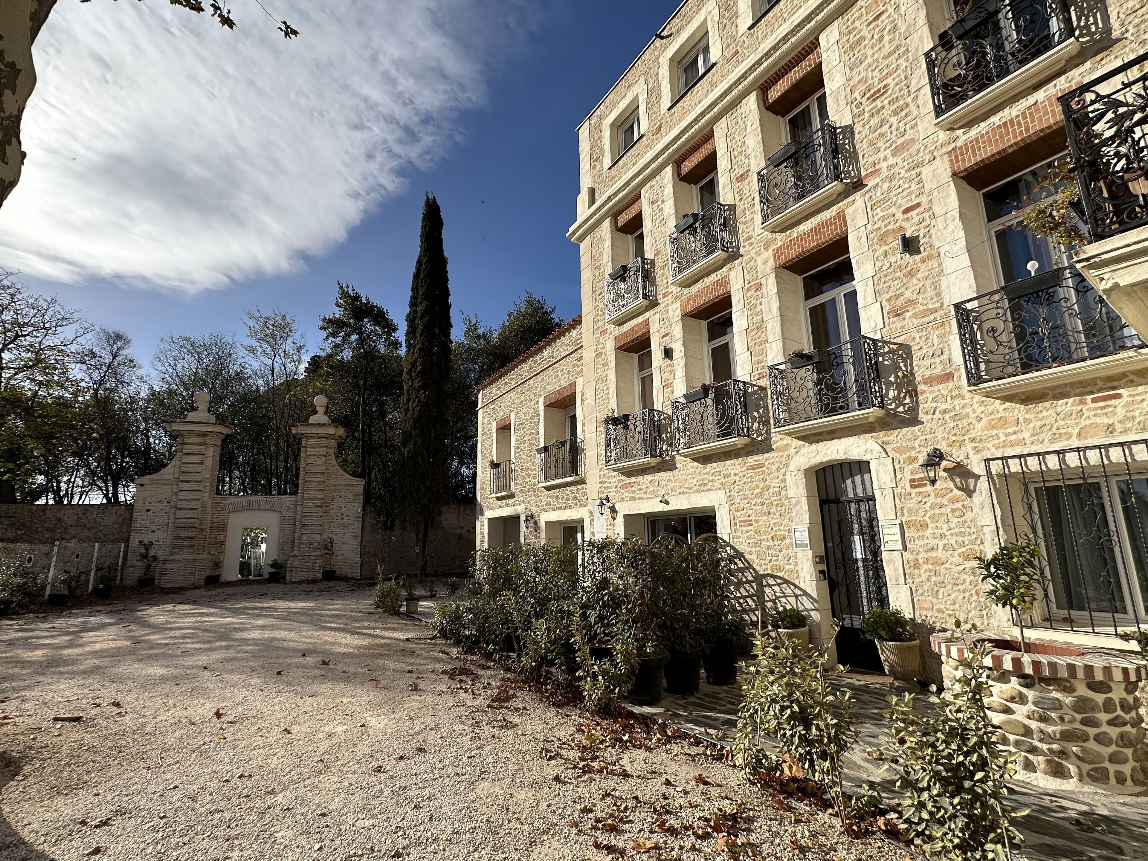 A stone building with multiple balconies and a courtyard.
