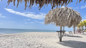 On the beach, sun loungers, beach towels