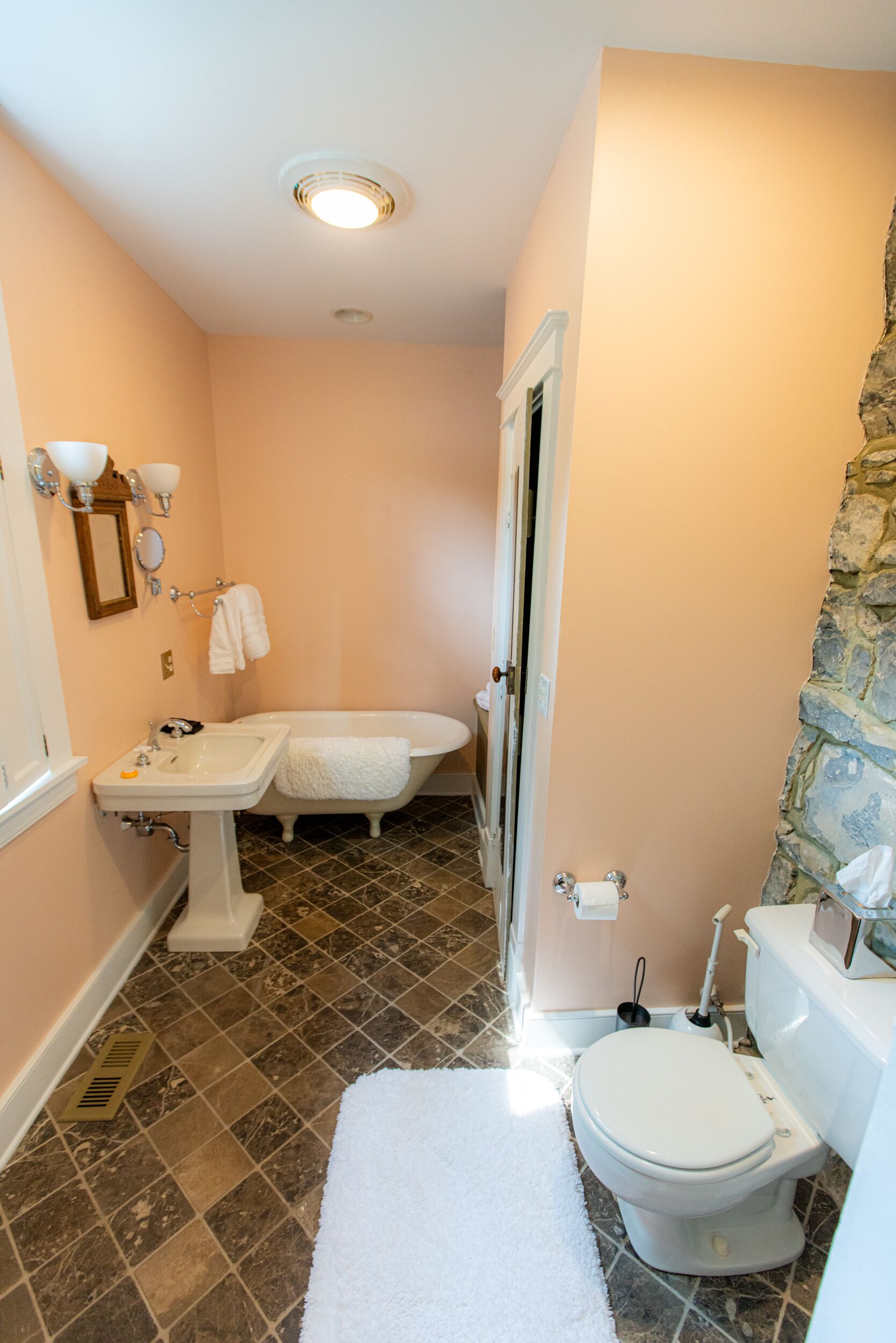 A bathroom with a sink, toilet, and bathtub.