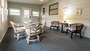 A room with a dining table and chairs, a ceiling fan, a lamp, and a window with blinds. - Sunshine and Relax! (Zephyr Hill)