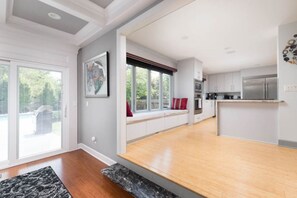 A modern kitchen with a wooden countertop, white cabinets, and a built-in oven. - Luxury in Lenexa w/heated pool (Lenexa)