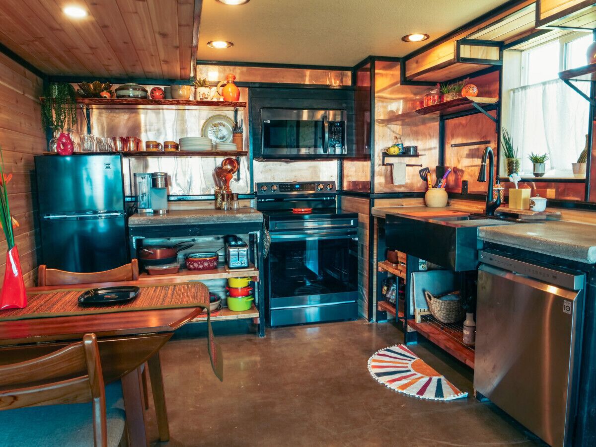 A compact kitchen with a microwave, oven, and dishwasher.
