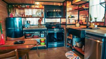 A compact kitchen with a microwave, oven, and dishwasher.