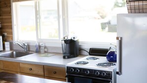 A kitchen with a stove, sink, and a window. - Rm 4 Sequim lavender · 4-Water View-Beach access-Sequim's Lavender Room (Sequim)