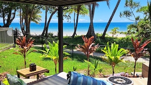 A covered outdoor seating area with a view of the beach and ocean. - Seadreams Mission Beach (Mission Beach)