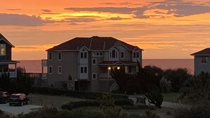 A residential area with houses during sunset. - Water Music OBX:  Ocean views, easy beach access, private pool.  Pet friendly. (Corolla)