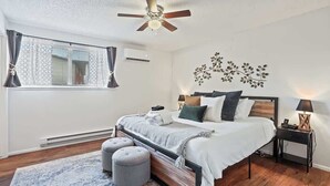 A bedroom with a bed, bedside table, and a ceiling fan. - Single Level Homestay - Prime Location (Boise)