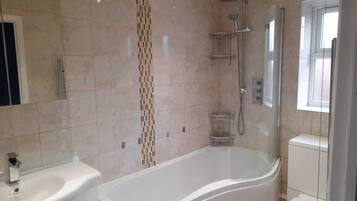 Combined shower/bathtub, towels, soap, toilet paper