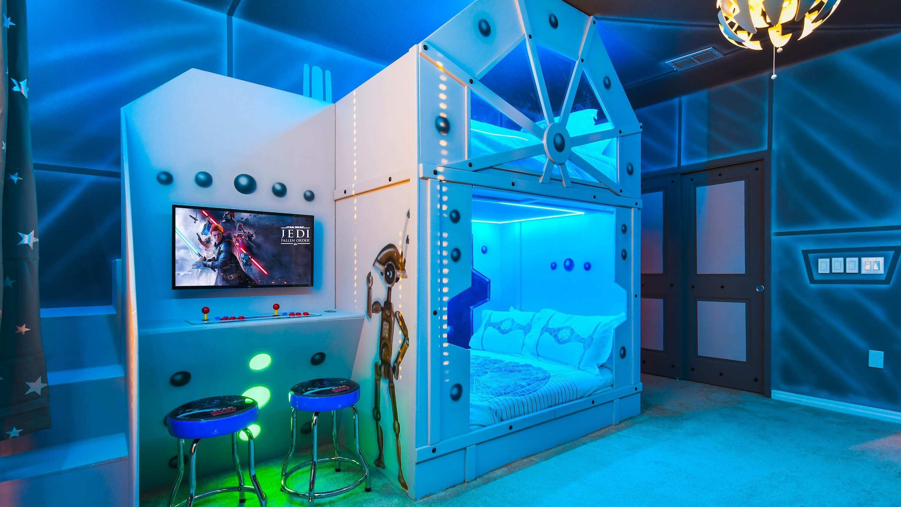 A Star Wars-themed room with a bed, a TV, and a robot figure.