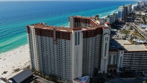 A high-rise hotel with a beach view, multiple floors, and a parking area. - Hook Wine & Sinker - Beachfront Condo, 6th Floor (Panama City Beach)