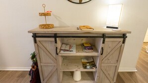 A wooden cabinet with shelves, a small plant, and a mirror. - 3BR Fall Creek Condo Near Table Rock Lake + Branson Attractions | FC 39-2 (Branson)