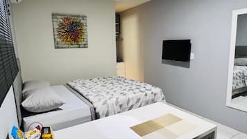 Suíte estúdio, 1 quarto, cozinha americana | Roupas de cama premium, frigobar, individualmente decorados