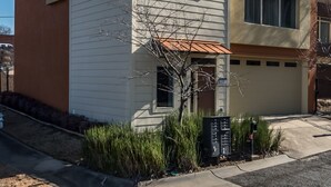 A two-story building with a flat roof and a small front porch.