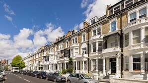 A row of terraced houses with a clear street in front.
