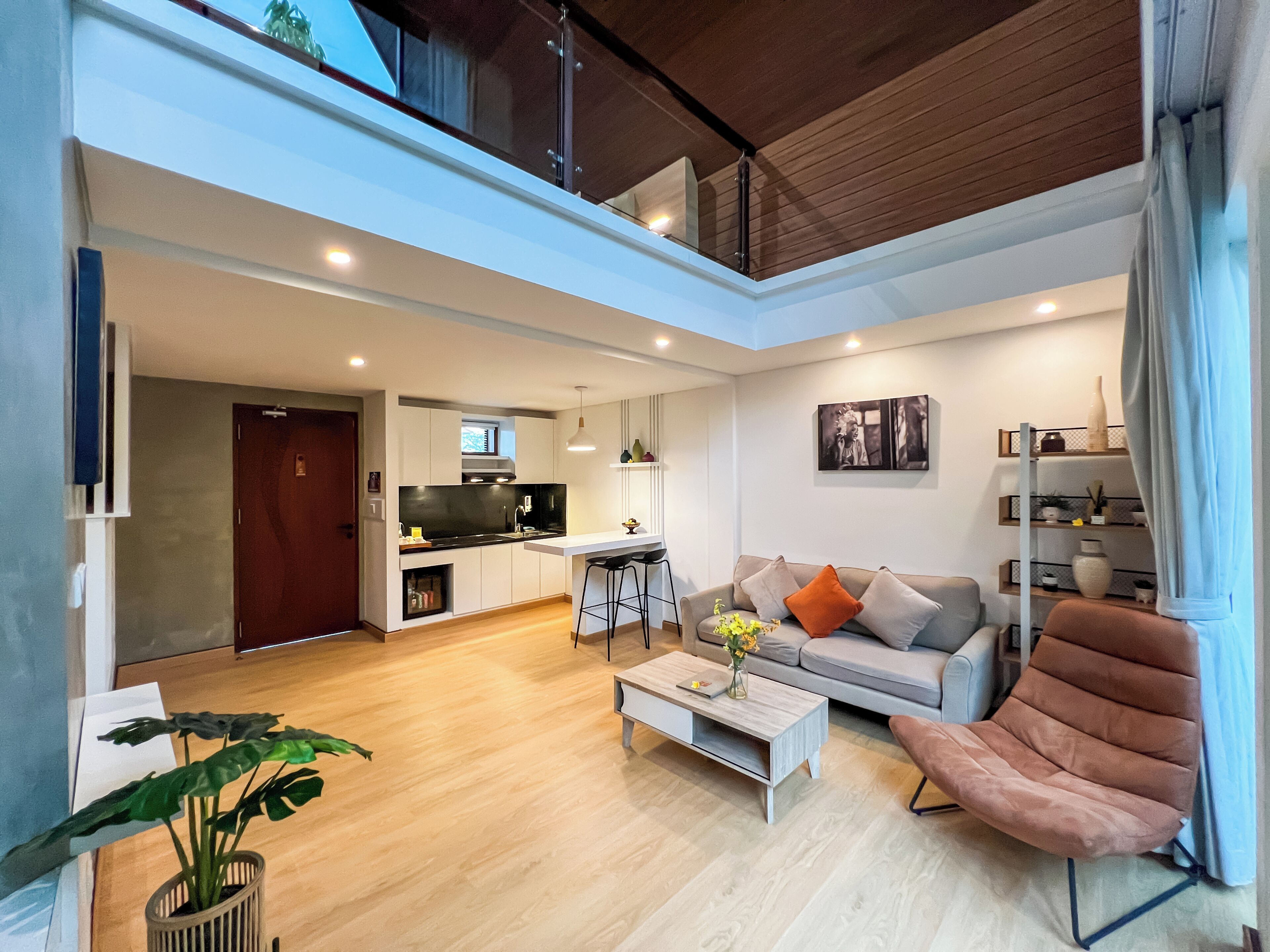 A modern apartment with a kitchen, living room, and dining area.