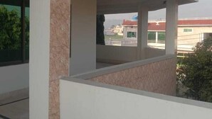 A modern building with a flat roof, large windows, and a covered outdoor area. - Impeccable 4-Bed Villa in Mirpur azad khasmir (Mirpur azad khasmir)