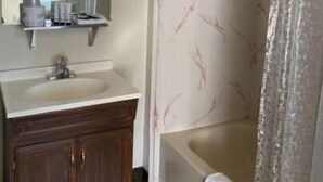 A bathroom with a sink, mirror, and shower. - Monte Bianco Inn (Mount Shasta)