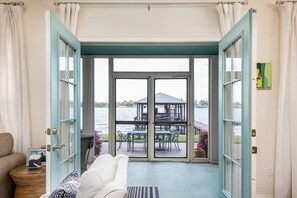 A room with a view of a dock and a gazebo by the water. - Screened porch and private pier on False River (Ventress)