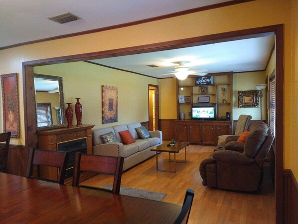 Relax in this inviting living room with a sofa, armchair, and dining table.