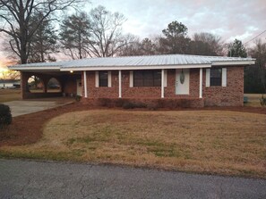 Welcome to this charming single-story home with a cozy front porch and inviting entryway.